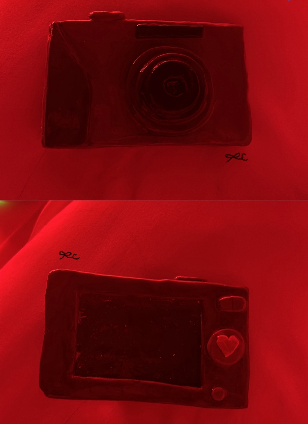 Two red-lit clay keychain studies, including a camera and a small screen.