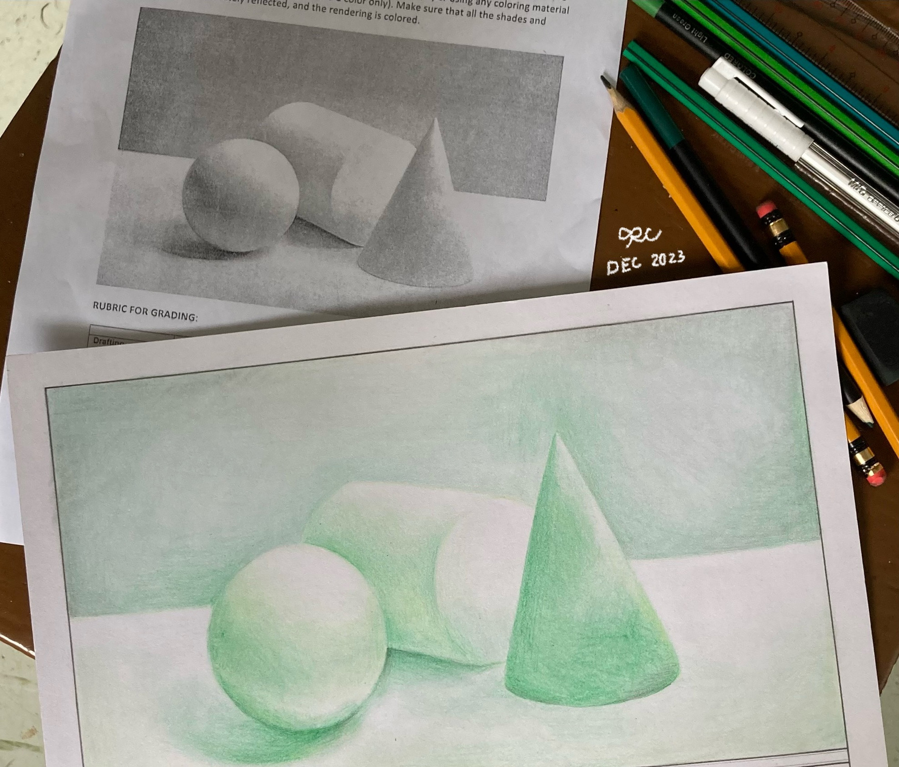 Watercolor studies of a sphere, cube, and cone beside pencils and reference material.
