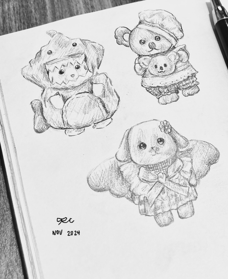 Pencil doodle sheet with several small rounded character studies.