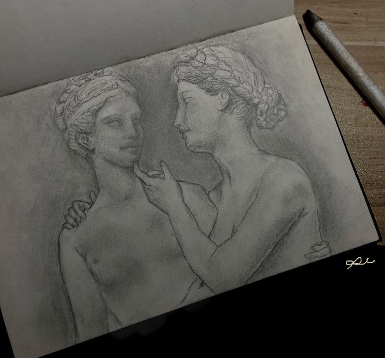 Pencil drawing of two seated figures on a sketchbook page.